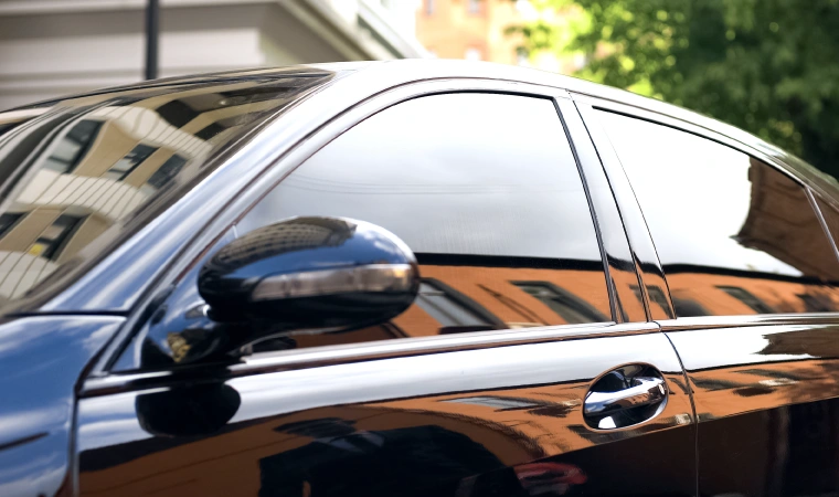 Black tinted windows on a black car.