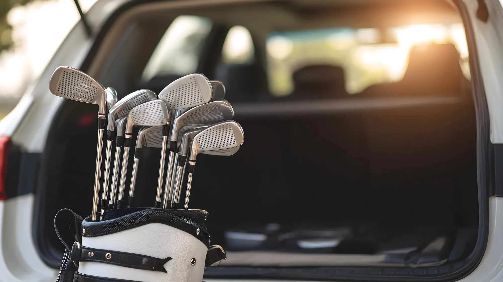 Golf clubs by a car