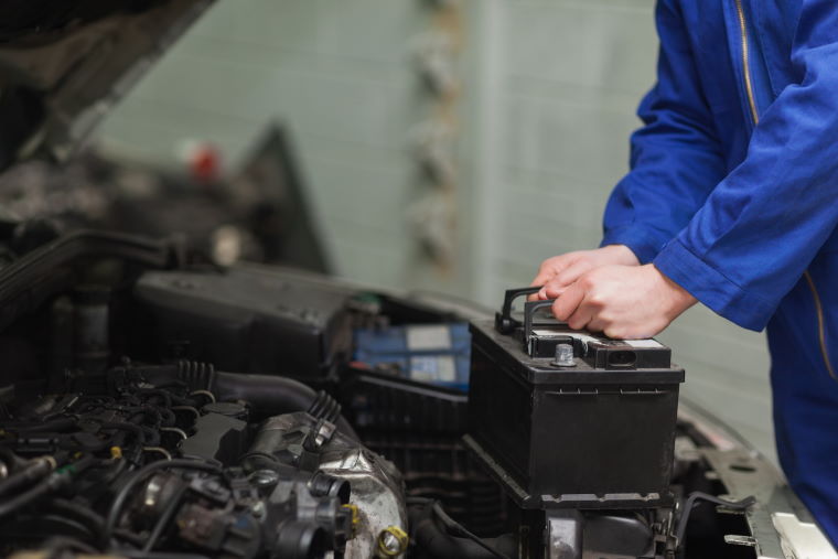 Mechanic changing a car battery