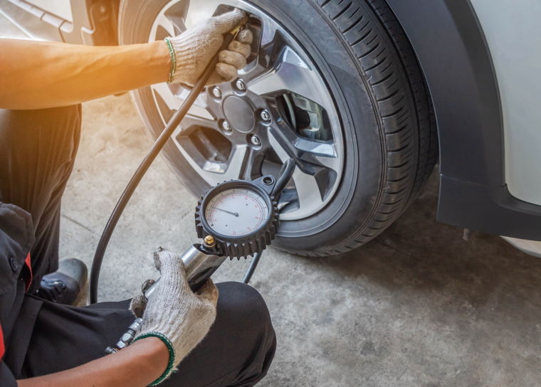 Technician pumping up a tyre